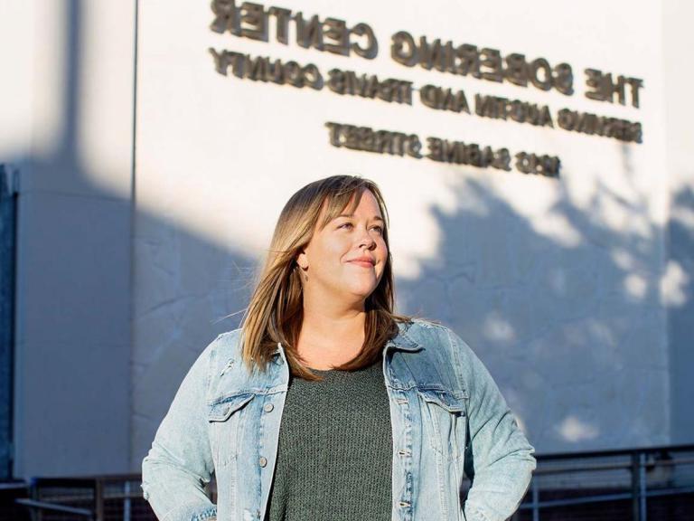 A person stands in front of a wall